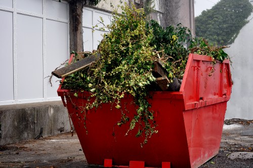 Local skip hire service assisting a homeowner